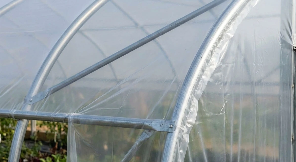 Close-up of IRAC greenhouse film stretched tightly over a metal hoop frame